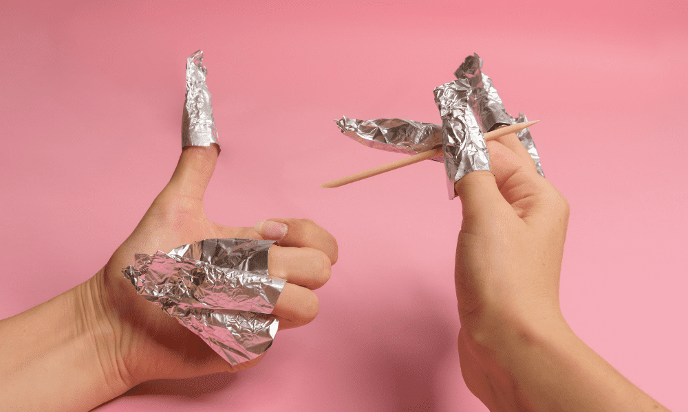 foil on fingers with a chop stick removing gel nails