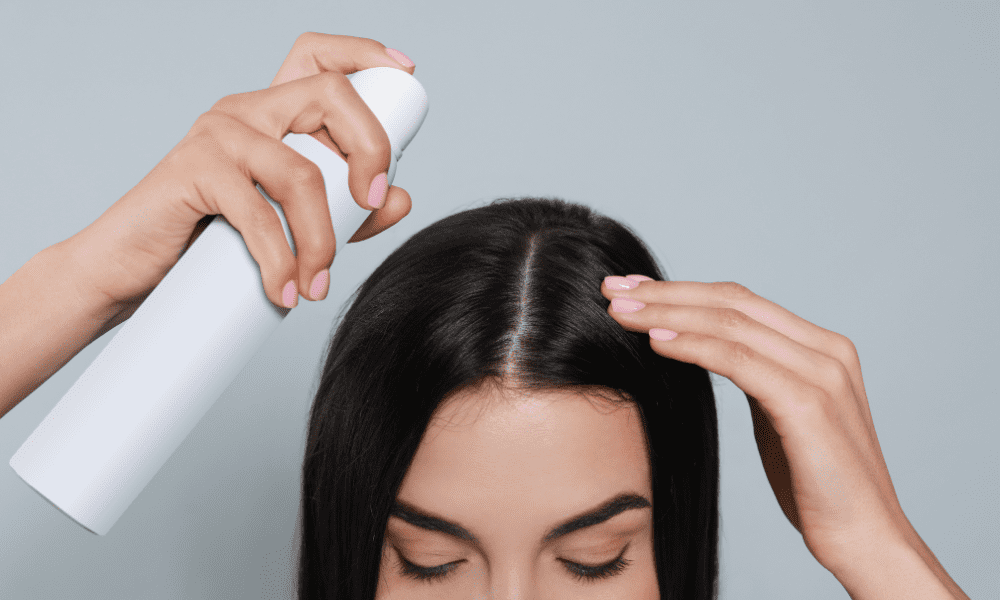 girl applying Dry Shampoo on her hair