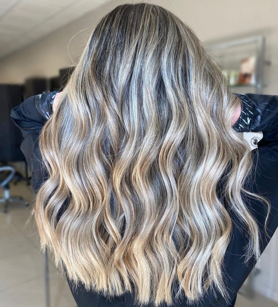 The blonde highlights make the hair appear longer and more voluminous