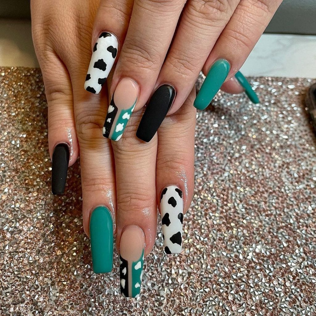 black green and white cow print nails