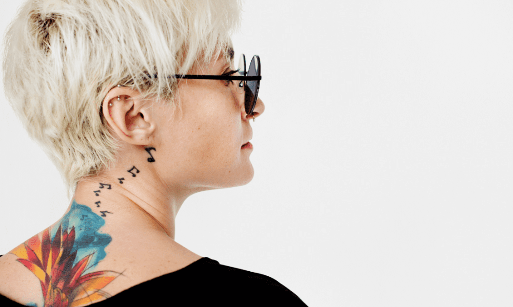 beautiful woman with music notes tattoo behind her ear