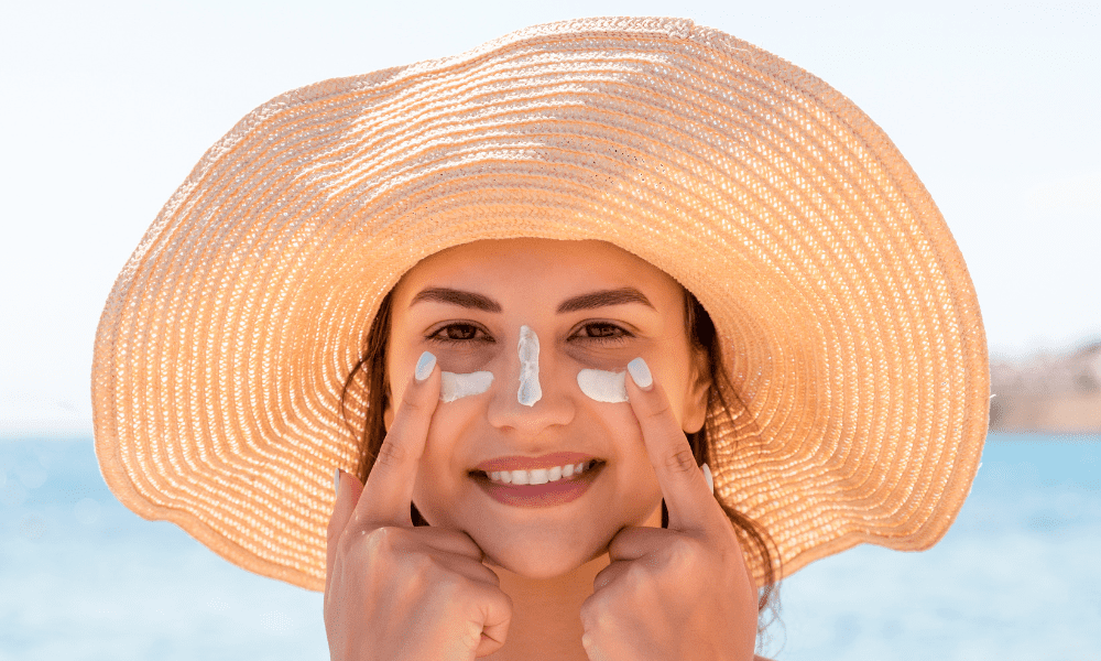lady wearing summer hat with sunscreen on her face