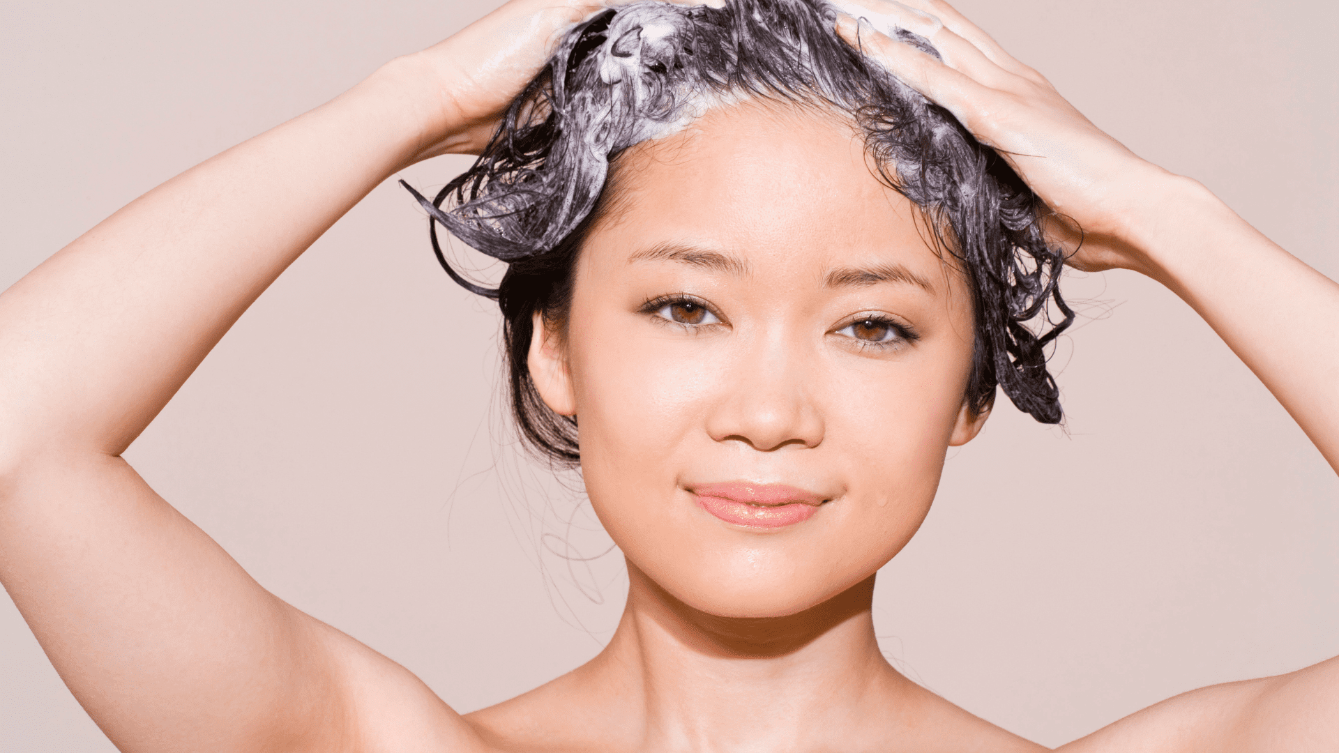 asian woman with shampoo in her hair